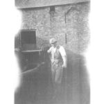 J W Peacock loading manure into cart in fold yard at East Grange Farm